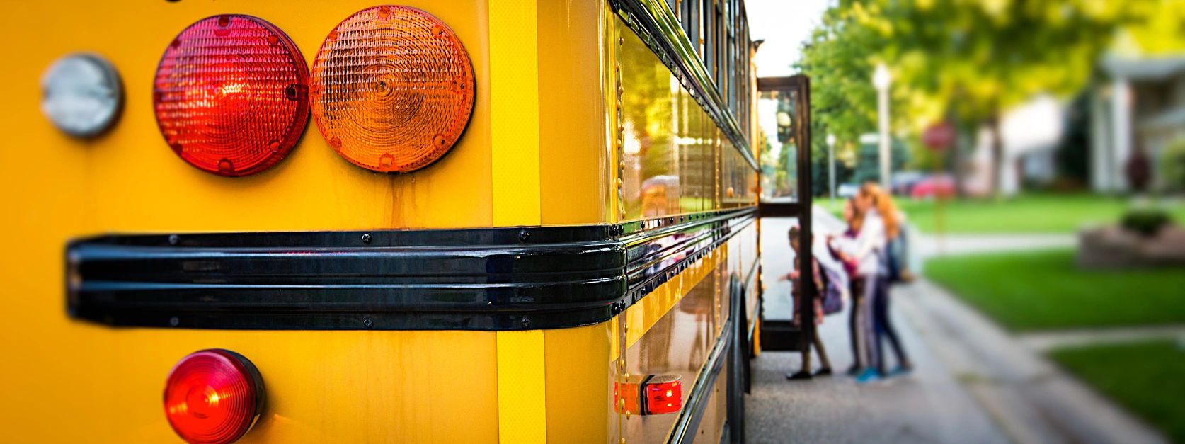 3 A yellow school bus parked on the side of the road.
